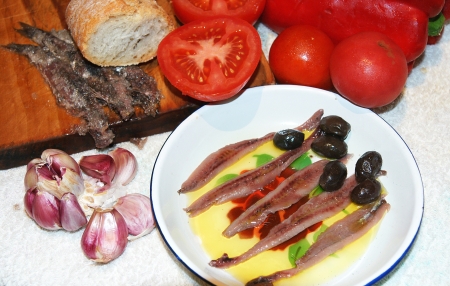 anchovy dish with tomatoes, olives and garlicの写真素材