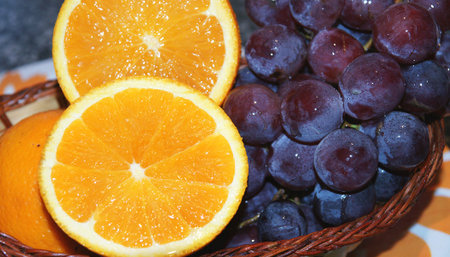 basket orange with bunch of grapes の写真素材