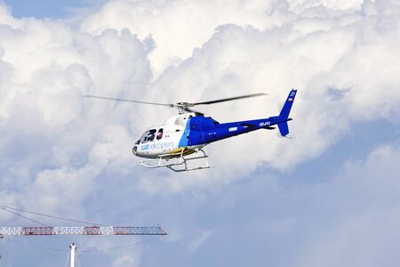 Helicopter flying in clouds in Barcelonaのeditorial素材