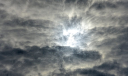 Sun between storm clouds