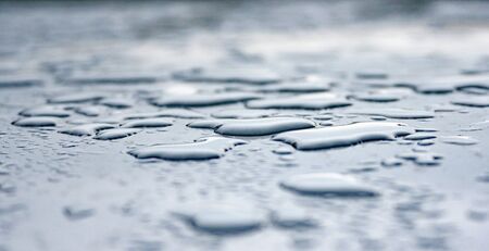 drops of rainwater on a steel surfaceの写真素材