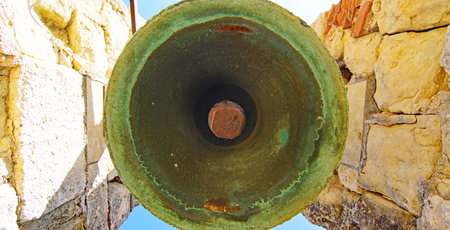 Old bell at the entrance to the church of St. John the Baptistの写真素材