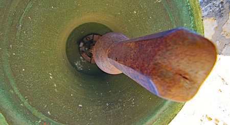 Old rusty metal bell on the street, close-up view.の写真素材