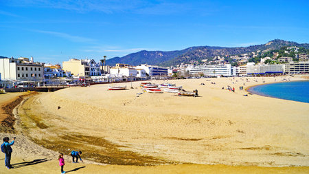 Boats stranded on the sand of the beach of Tossa de Mar, Costa Brava, Girona, Catalunya, Spain, Europeの写真素材