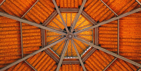 Ceiling of a gazebo made of wooden beamsの写真素材
