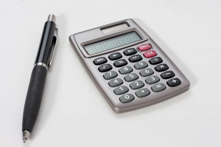Close-up of a calculator and a penの写真素材