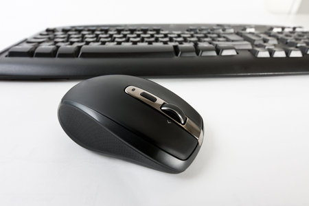 Close-up of a wireless Copmutermaus with a wireless computer keyboard in the background
