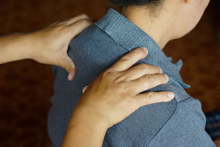 Closeup hands massage woman's shoulders. Concept, healthcare. Elderly health problem, backache and...