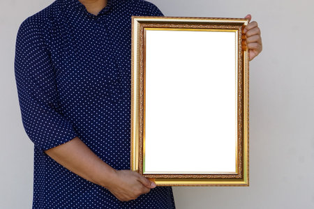 Closeup woman holds empty photo frame or blank diploma certificate frame. Copy space for adding text...
