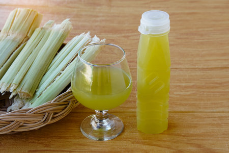 Bottles of fresh sugar cane juice.  and bagasse after squeezing for a drink in basket. Concept, healthy natural beverage made from agriculture crop. Homemade drinks.の写真素材
