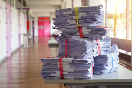 Stack of used paper test after the examination in front of classroom, combine to use next time or...