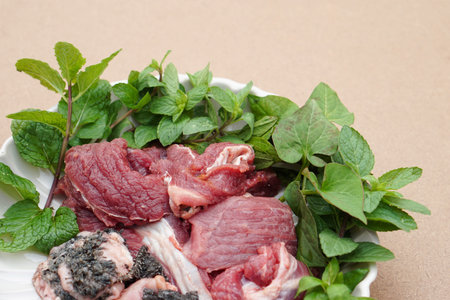 Fresh raw beef and Thai local herbal vegetables, prepare for cooking. Concept, food ingredient. Tradiotnal weird food. Popular menu in northern of Thailand.  Local food.の写真素材