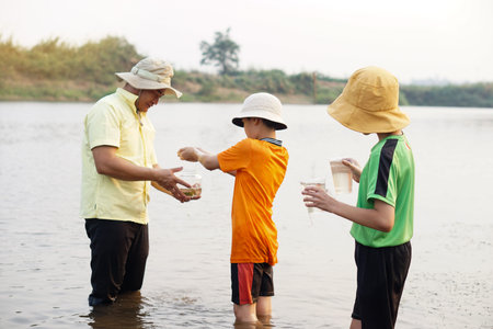 Asian man teacher and students are exploring water from nature source. Concept, Ecology and...