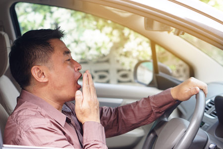 Asian man yawn in car, feels asleep while driving. Concept, campaign to stop driving  with drunk,...