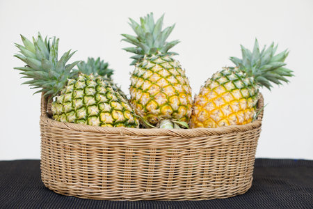 Basket of organic pineapple fruits. Concept, Agriculture crop in Thailand. Thai farmers grow pineapple to sell, eat in family or share to neighbors. Seasonal fruits, can eat.の写真素材