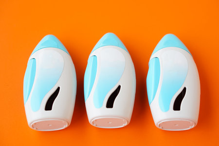 Three nasal spray suspension on orange background.  Concept, Pharmaceutical products for treatment symptoms of allergic rhinitis. Use under prescription. Health care medical deviceの写真素材