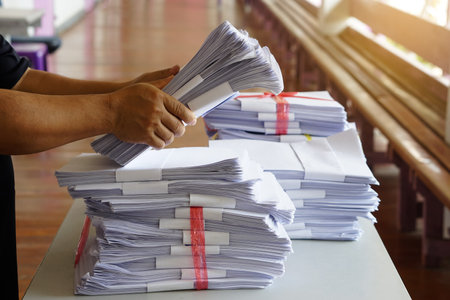 Closeup hands hold stack of used paper, combine to use next time or take to recycle process. Concept, eco friendly activity. Waste paper management. Reduce reuse, recycle paper.の写真素材