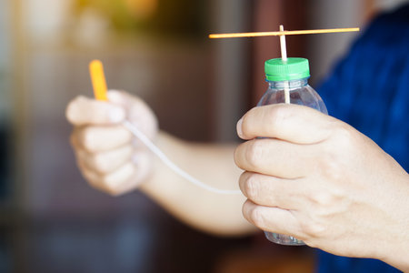Close up DIY toy helicopter made of waste and plastic bottles and ice cream sticks. Concept, Recycle crafts. Toy for kids, Teaching aid, fun activity for active learning.の写真素材