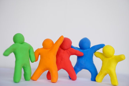 Colorful plasticine people. Human figures from plasticine sculpture. Concept, friendships, partnerships and relationships between people. Sculting enhance imagination.の写真素材