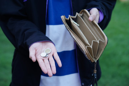 Close up hands holding empty wallet and shows Thai coins money. Concept, poor, bad economic crisis. Financial problems. Broke or less money at the end of month.の写真素材