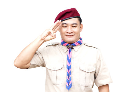 Handsome Asian man wear boy scout uniform, red cap, blue and pink striped scarf, make hand sign symbol, isolated on white background.  Concept, educational career with uniformの写真素材