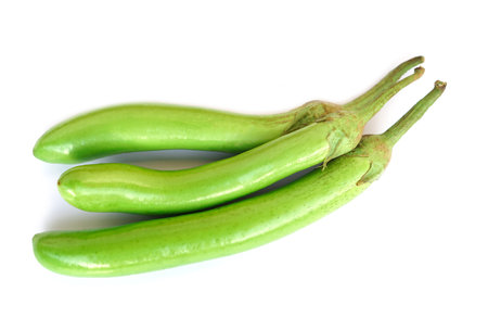 Green long eggplants isolated on white background. Concept, agriculture crop in Thailand. Food ingredient which can be cooked for variety delicious menu. Healthy eating, high fiberの写真素材