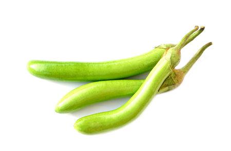 Green long eggplants isolated on white background. Concept, agriculture crop in Thailand. Food ingredient which can be cooked for variety delicious menu. Healthy eating, high fiberの写真素材