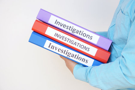 Close up a detective officer holds investigation folders. Concept, crime. Analyzing criminal investigation.の写真素材