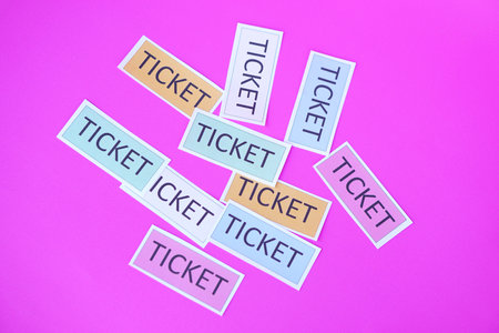 Tickets, paper cards on  pink background. Concept, tickets for passing or enter to join activity or public vehicles. Tickets for playing games. Teaching aids.の写真素材