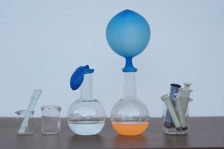 Laboratory glassware with blue liquid and test tubes on the table