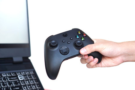 Close up hands hold black joysticks or game controller console. Concept,technology device for...