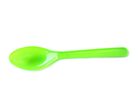 Green plastic disposable spoons isolated on white background. Concept, equipment for eating utensil, can be reuse or recycle to made DIY craft.の写真素材
