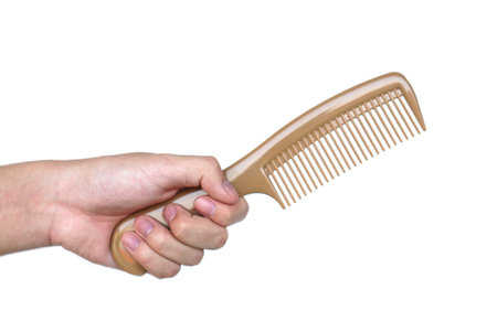 Close up hand hold brown comb isolated on white background.  Concept, Hair beauty tool for hairstyle...