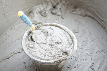 Bucket of well mixed cement and sand for construction with a trowel. Concept. Construction  job....