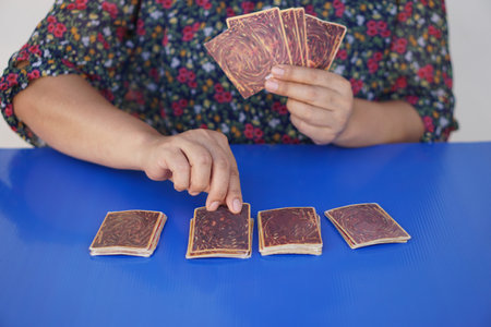 Close up hands hold, choose and pick up paper cards. concept, fortune reading. astrology. Foretelling, mystery, magic, fortune, fate. Prediction for future life ,events.の写真素材