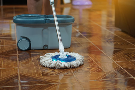Close up of man using a mop to mop the floor. Concept, chore. Household. Housework. Cleaning house....