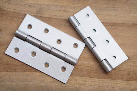 Hinges on wooden board. Concept, Tools or equipment for craft, diy, fix or repair furniture....