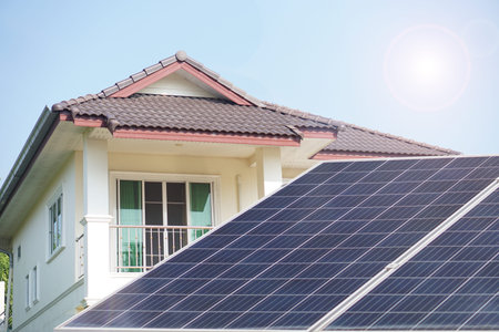 Photovoltaic or solar panels with house. Concept using solar energy to generated electricity  for...