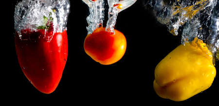 Bubbles of water with  tomato and Pepper  background Blackの写真素材
