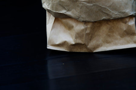 Brown paper bag on a black background.