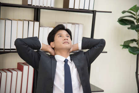 Business men show much thought Put your hands on your headの写真素材