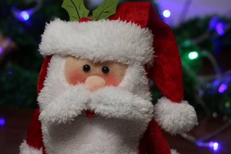 Toy santa clause with lights on background. Winter is coming. Holiday mood.の写真素材