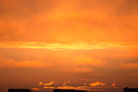 clouds at dawn. Fiery red rising sun behind the clouds. headpiece