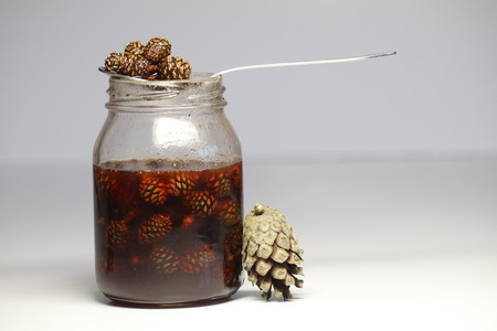 unusual jam from cones, creative for health. forest gifts, sunsets. stocks for winter. healthy sweets. the bumps next to the jarの写真素材