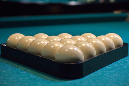 balls for Russian Billiards are lined with pyramid at the beginning of the game. white balls on a green table. serious sport, championshipの写真素材
