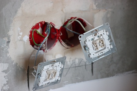 installation of sockets and switches, 220 volt connector for the Internet. rough finish in repair. electrical work in the remake. remodeling with an interior designer.の写真素材