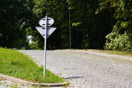 a bent road sign, bent post. traffic regulations. road safetyの写真素材