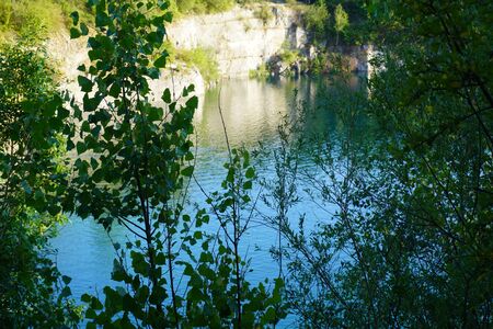 lake among the rocky mountains, turquoise clear water, wild nature, the sun's reflection in water, reflection of mountains in clear waterの写真素材