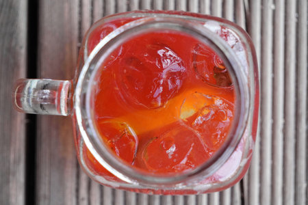 summer soft drink of fresh fruits and berries, cold mineral water, ice and mint in glass with...