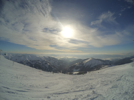 winter clear day in mountains, the sun in the foggy clouds, the view into the distance, the photo...